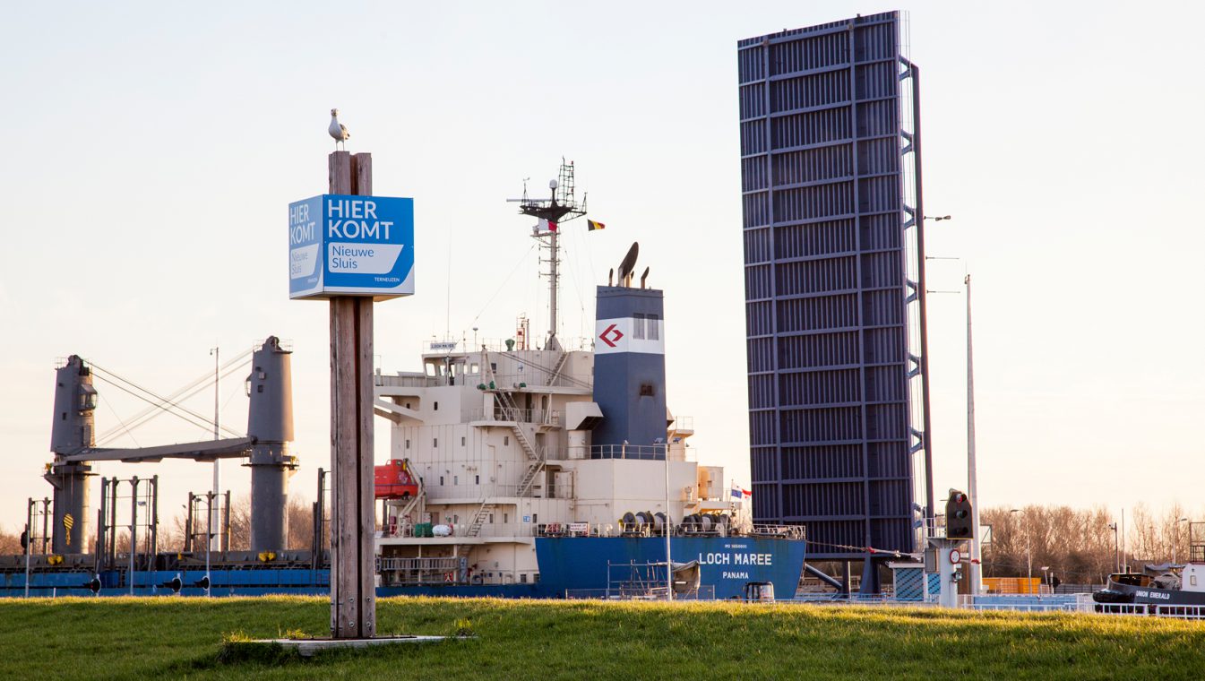 Paal met de aankondiging 'Hier komt de Nieuwe Sluis Terneuzen'